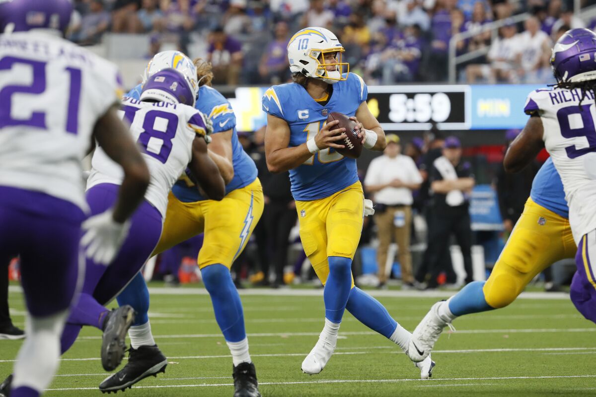Chargers quarterback Justin Herbert (10) drops back to pass against the Vikings.