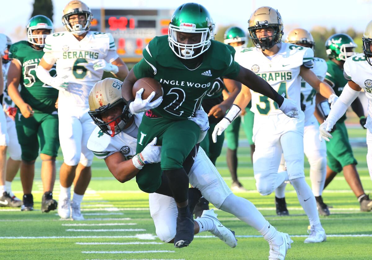 Running back Zion Garrett carries the ball 