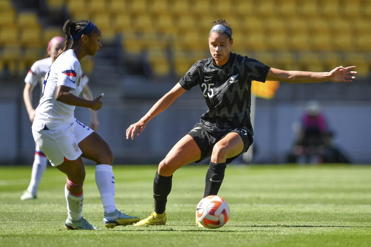 United States' Crystal Dunn and New Zealand's Grace Jale compete for the ball.