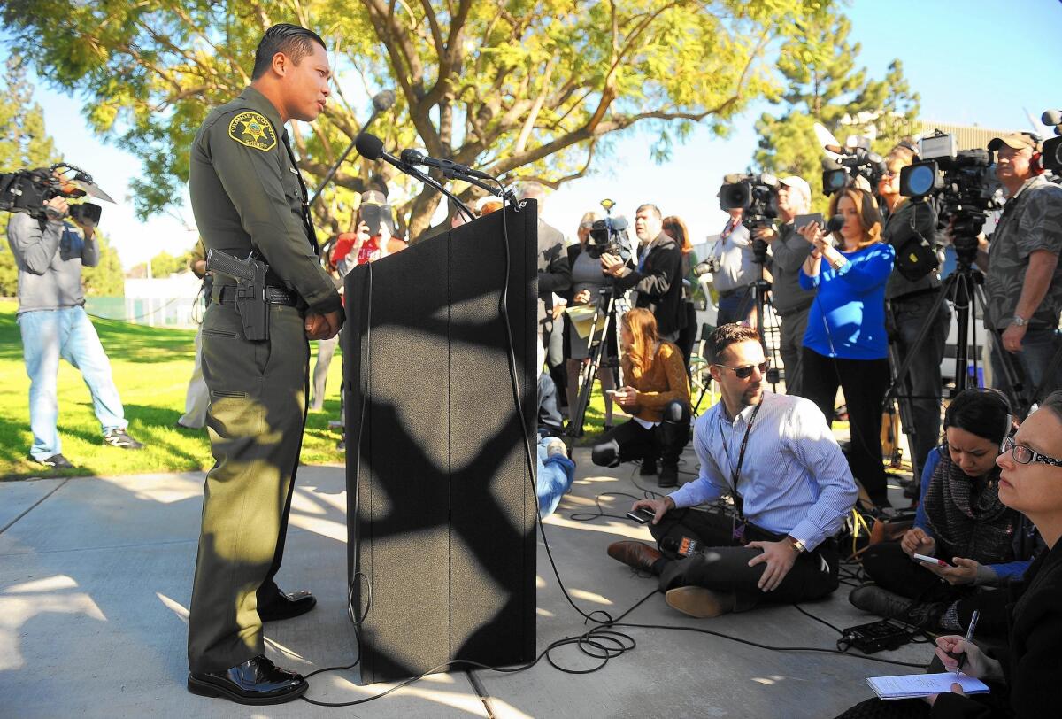 Phuong Nguyen, an Orange County Sheriff's deputy, speaks to the media in Vietnamese at a news conference in Santa Ana.