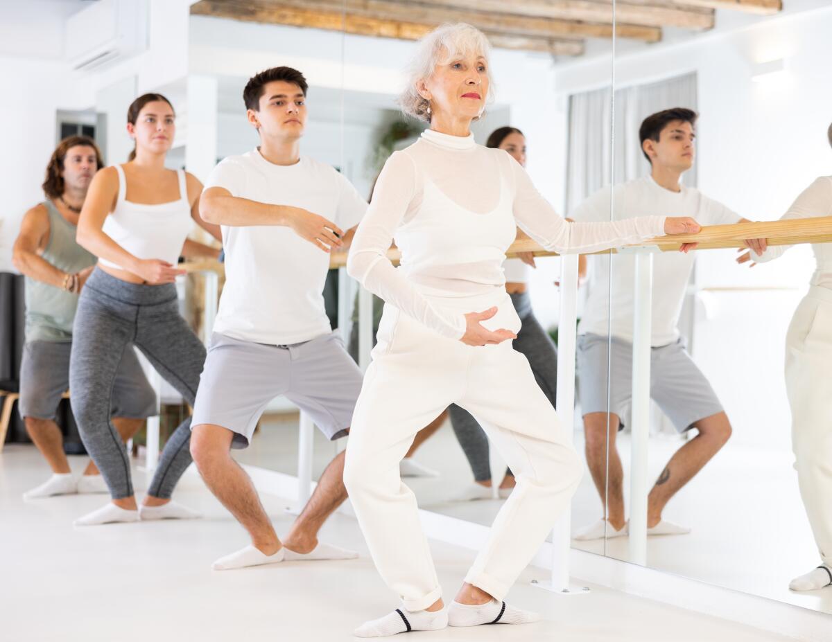 Participants pose beside a mirror for a Ballet for All Masterclass.