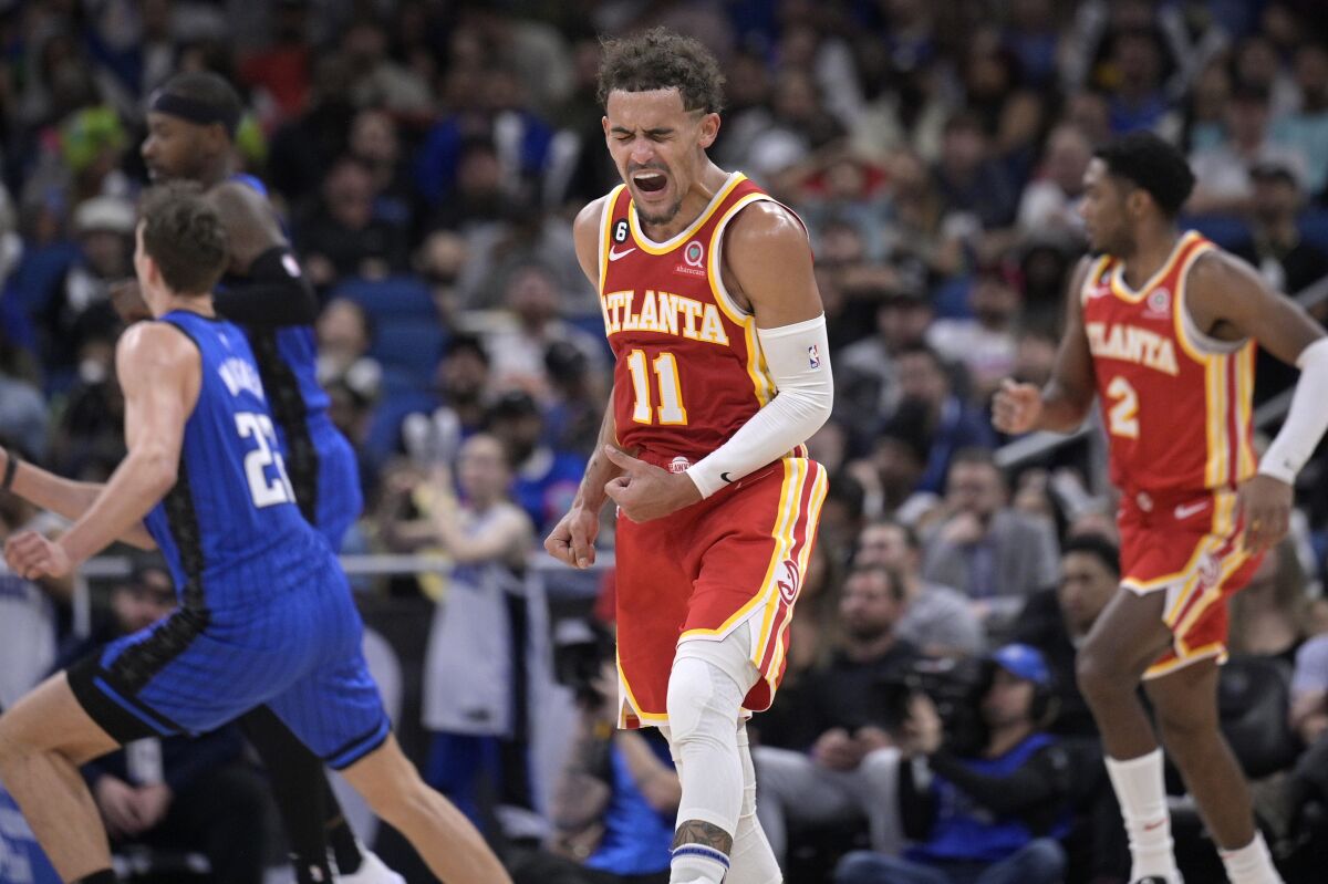 Atlanta Hawks guard Trae Young (11) reacts after a score during the second half of the team's NBA basketball game against the Orlando Magic, Wednesday, Nov. 30, 2022, in Orlando, Fla. (AP Photo/Phelan M. Ebenhack)