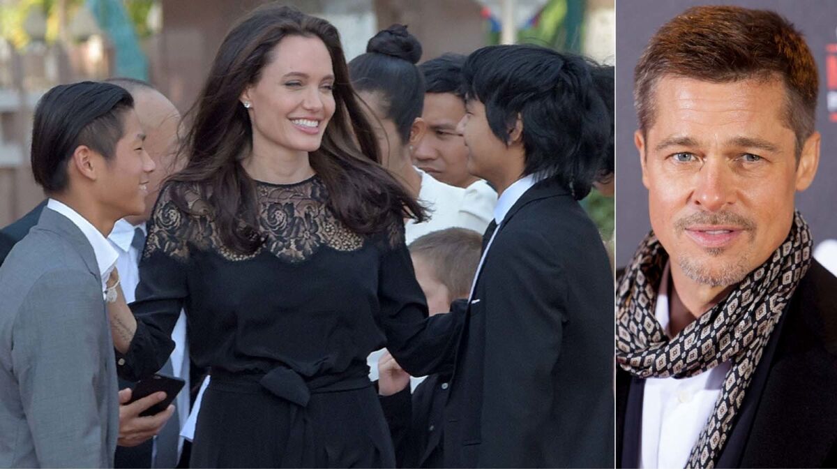 Angelina Jolie Pitt with sons Pax, left, and Maddox; Brad Pitt, right.
