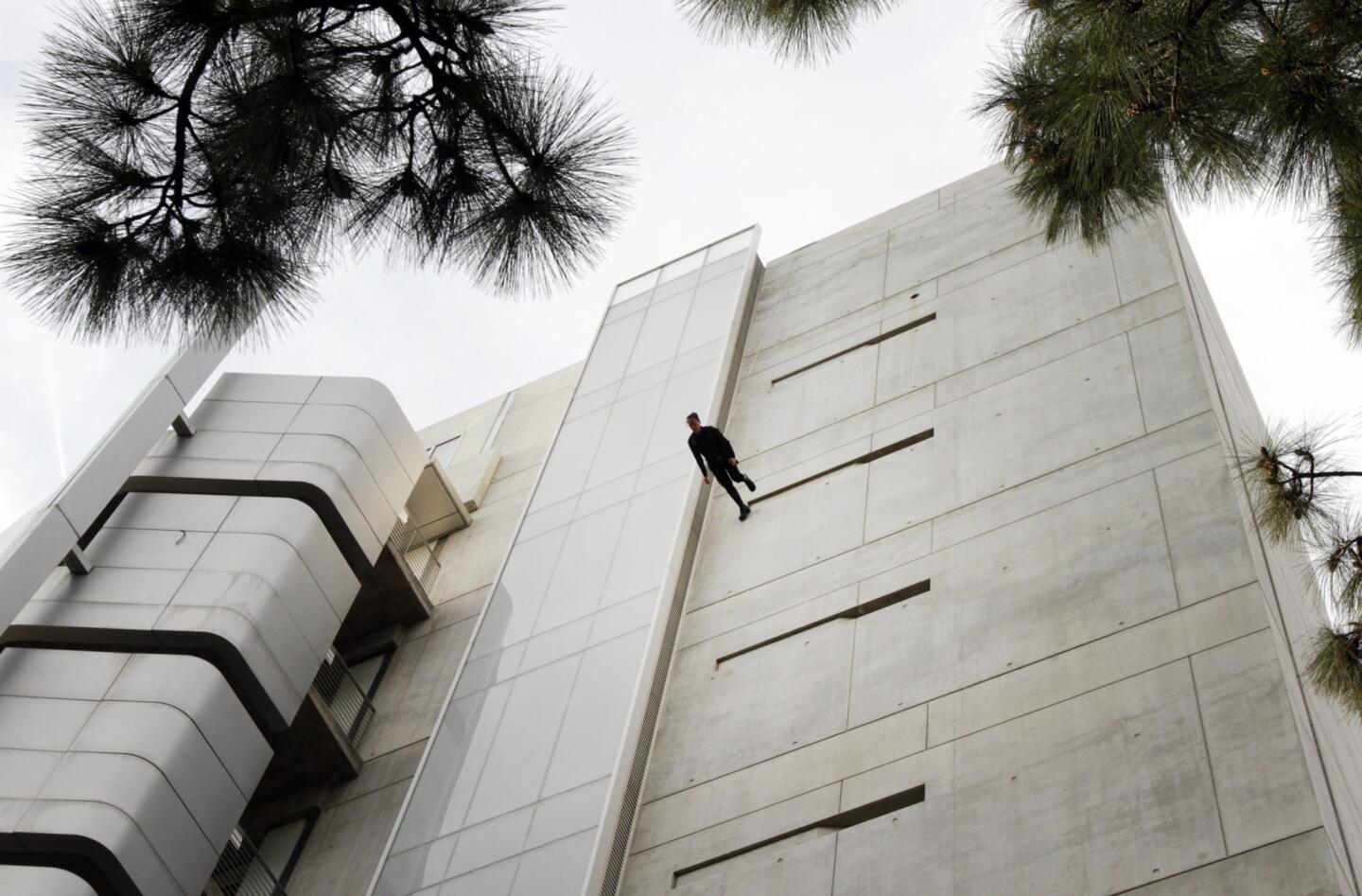 'Man Walking Down the Side of a Building'