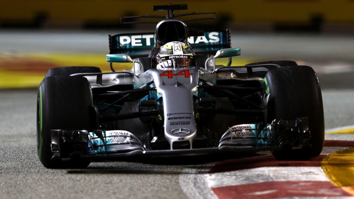 formula One driver Lewis Hamilton guides his car through a series of turns at the Marina Bay Street Circuit during the Singapore Grand Prix on Sunday.