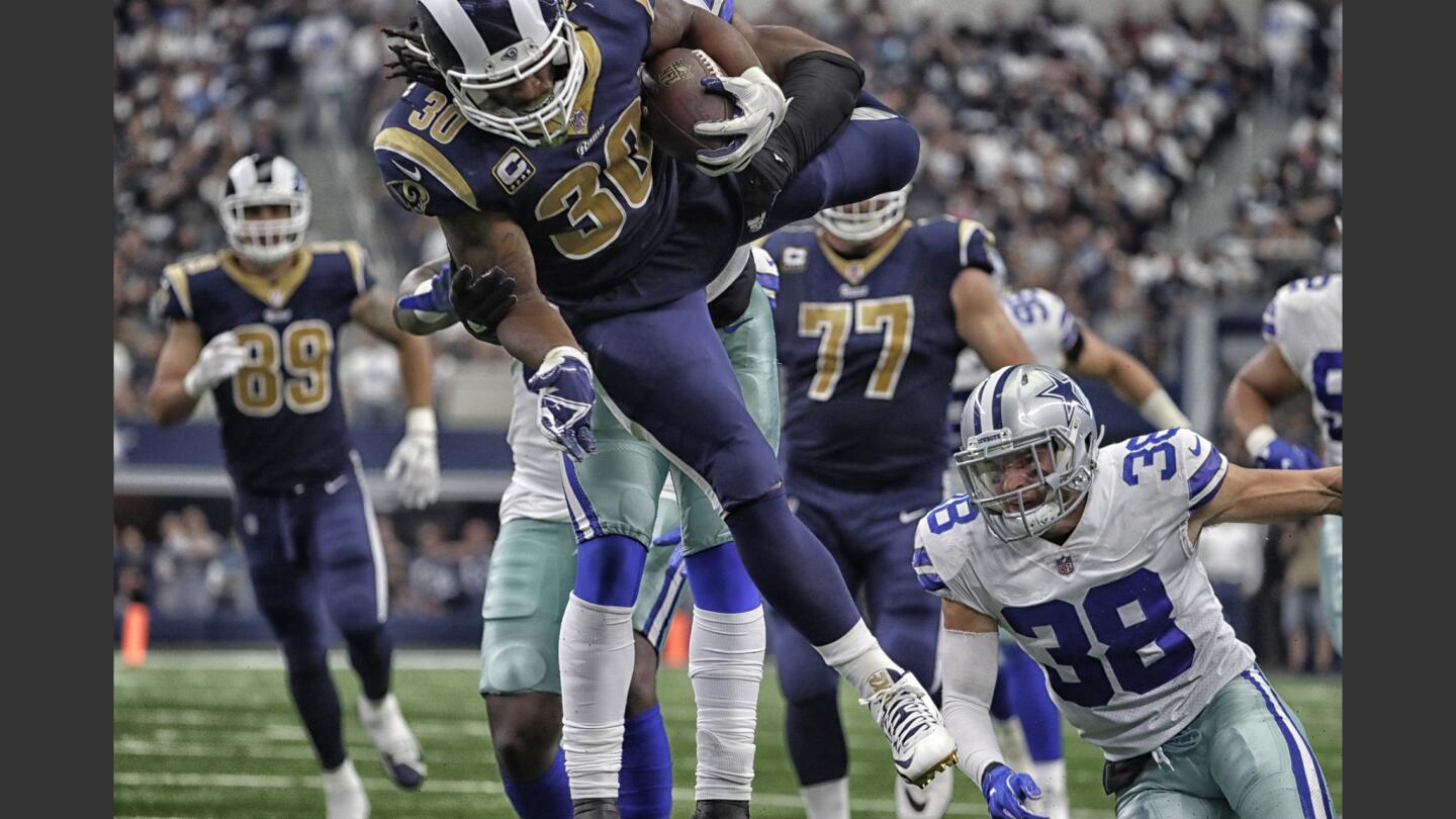 Rams running back Todd Gurley leaps over Cowboys defenders during a third-quarter drive.