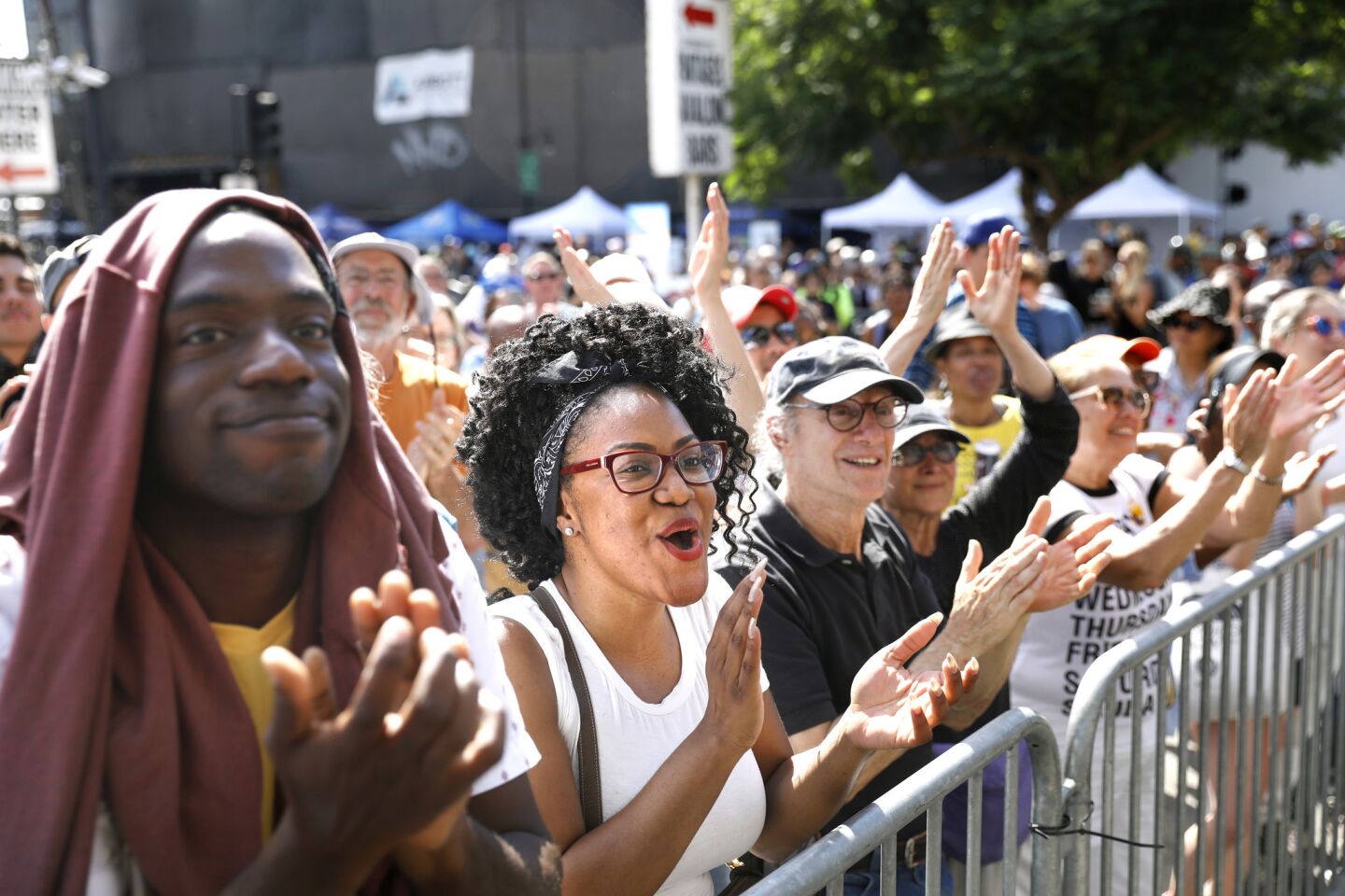 A crowd including Michael Boateng, 35, and Jasmine Anderson, 30, from left, joins in CicLAvia: Celebrate LA!, a daylong, eight-mile musical street-fair extravaganza.