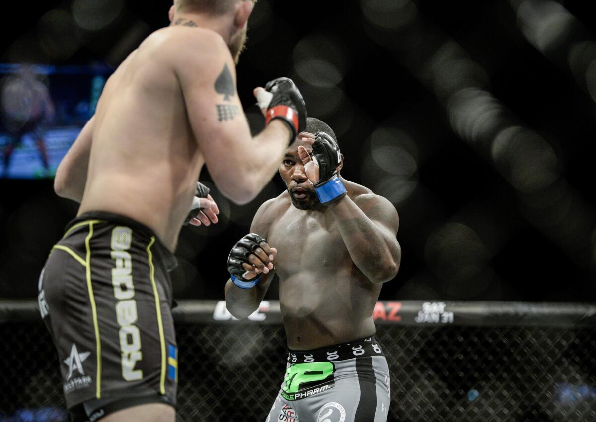 Anthony Johnson faces up with Alexander Gustafsson, left, during a UFC light-heavyweight bout in Sweden on Jan. 24.