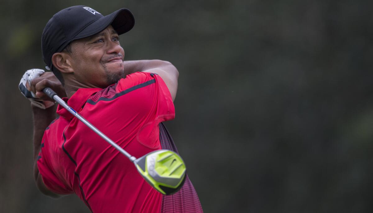 Tiger Woods tees off on the fourth hole during the final round of the Hero World Challenge in Windermere, Fla. Woods announced Friday he will open the 2015 season at the Waste Management Phoenix Open.
