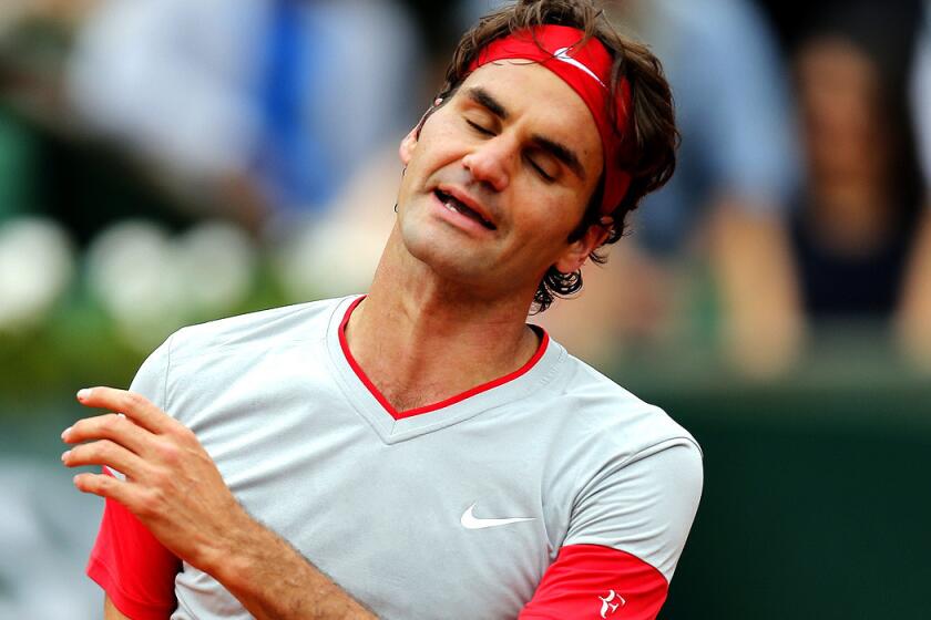 Roger Federer reacts after losing a point to Ernests Gulbis during a fourth-round loss at the French Open on Sunday.