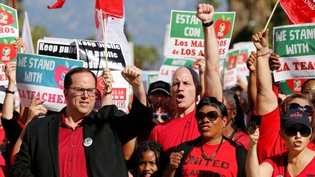 UTLA President Alex Caputo-Pearl, left, joins teachers at a rally in downtown Los Angeles on Dec. 15.