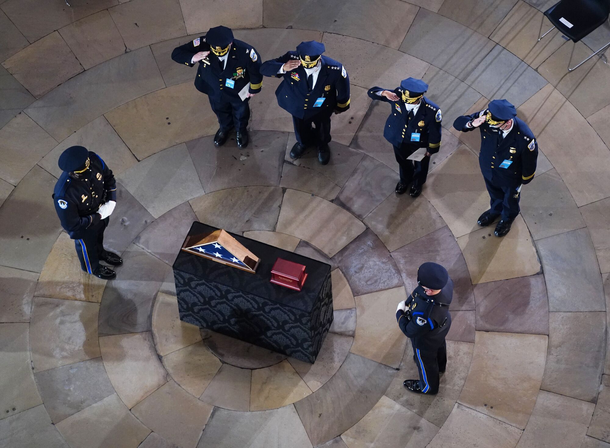 Police officers pay their respects at the memorial service in the Capitol 