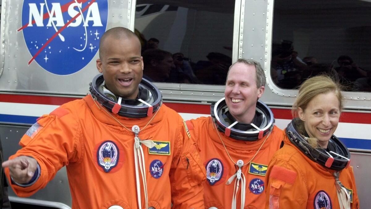 Space shuttle Atlantis mission specialists Robert Curbeam, Thomas Jones and Marsha Ivins, from left, leave crew headquarters Feb. 7, 2001, at Cape Canaveral, Fla.