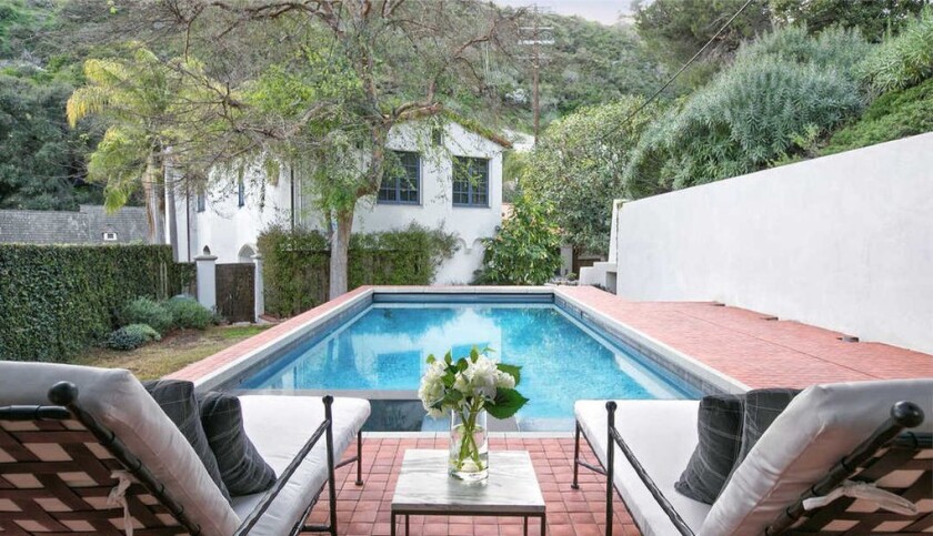 The Mediterranean-style spot includes a courtyard, a tiered patio and a swimming pool.