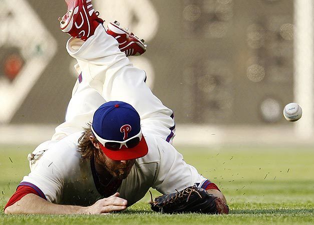 The Philadelphia Phillies' Jayson Werth dives but cannot come up with a single by the Washington Nationals' Ian Desmond in the ninth inning of a baseball game. Washington, won 7-5.