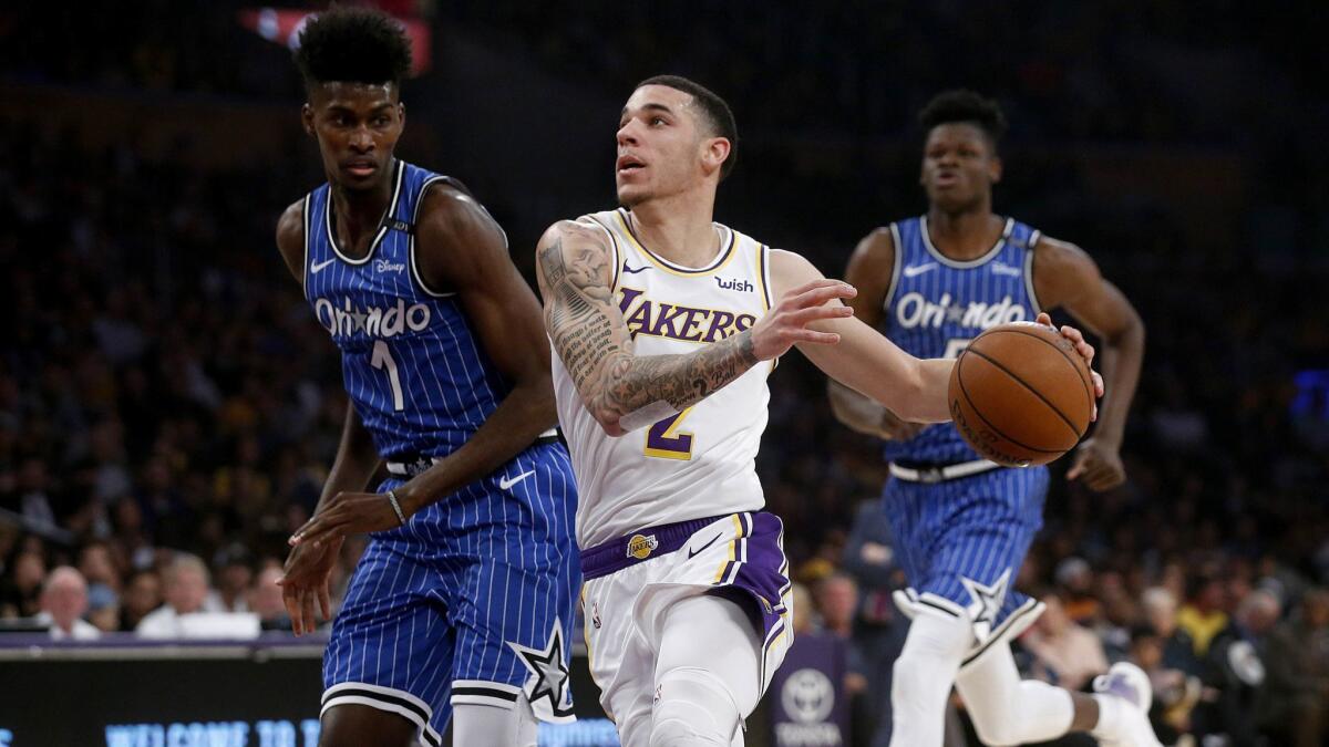 Lakers guard Lonzo Ball drives to the basket in front of Orlando Magic forward Jonathan Isaac at Staples Center in November.