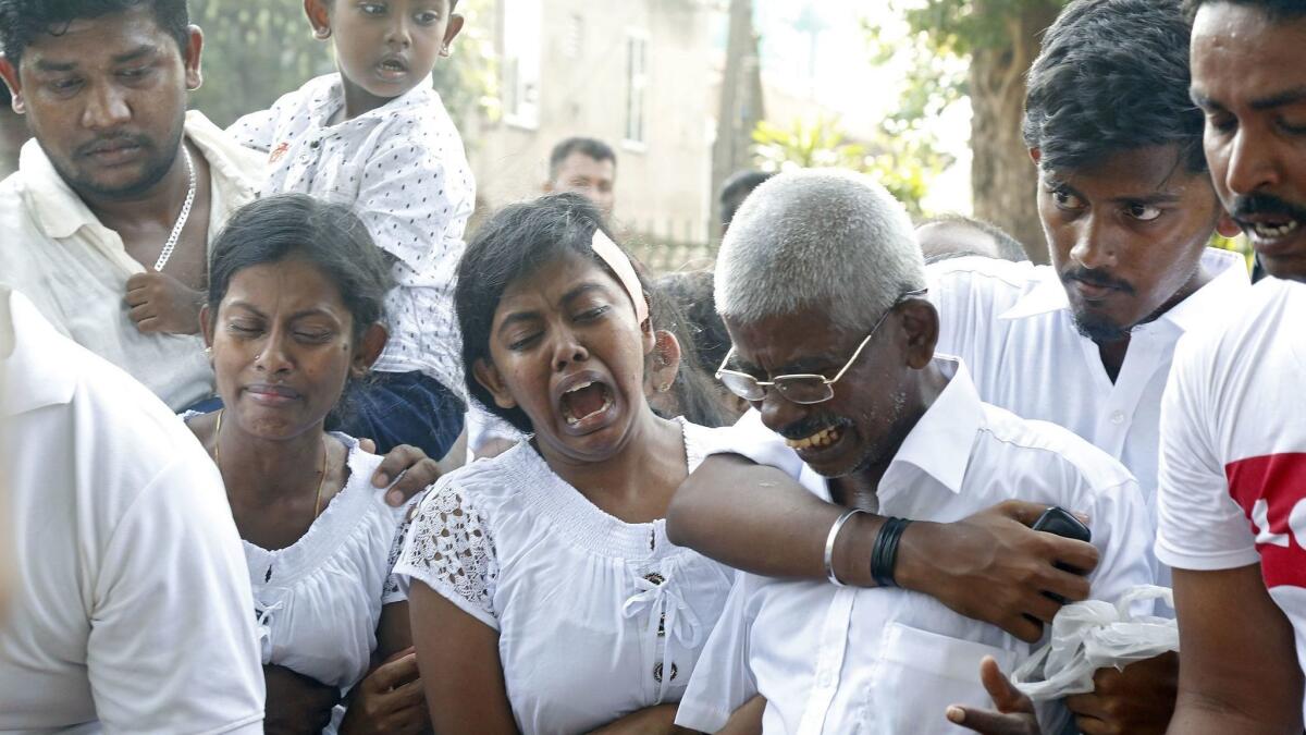 Relatives and friends mourn at Madampe Cemetery in Colombo, Sri Lanka, on Wednesday as they bury victims of Sunday's bomb blasts.