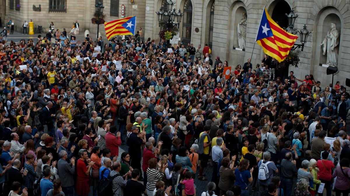 Crowds of people, some chanting “Independence,” gathered in the Placa Sant Jaume in Barcelona.
