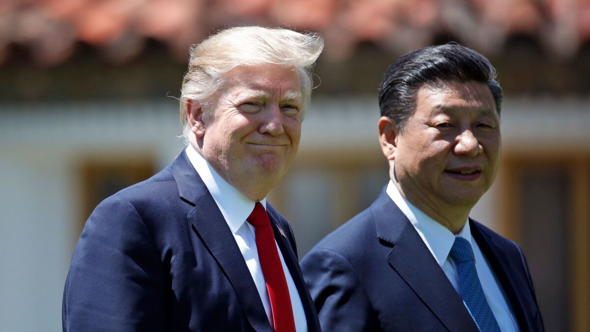 Donald Trump and Chinese President Xi Jinping walk together after their meetings at Mar-a-Lago in Palm Beach, Fla. on April 7.