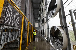 Towering structures of fans and trays capture carbon dioxide inside a direct air capture plant.