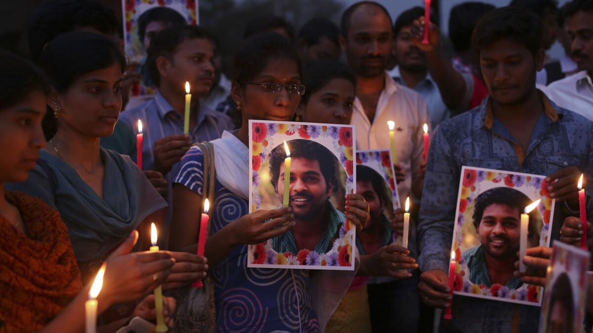 Activists of a Dalit organization participate in a candlelight vigil holding photographs of Indian student Rohith Vemula in Hyderabad, India, Wednesday, Jan 20, 2016.