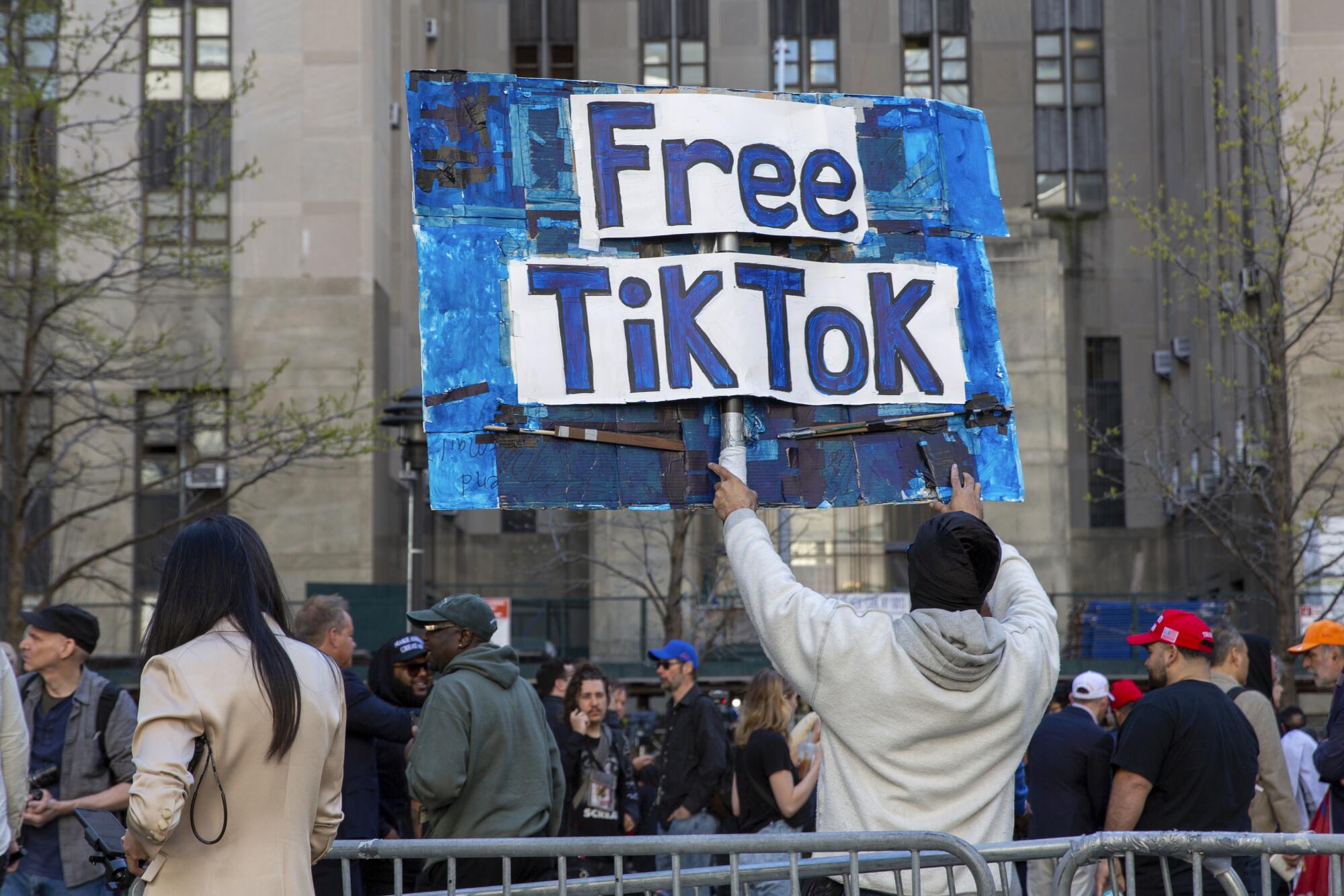 A man holding a sign reading, "Free TikTok" among a crowd gathered outside a New York City courthouse