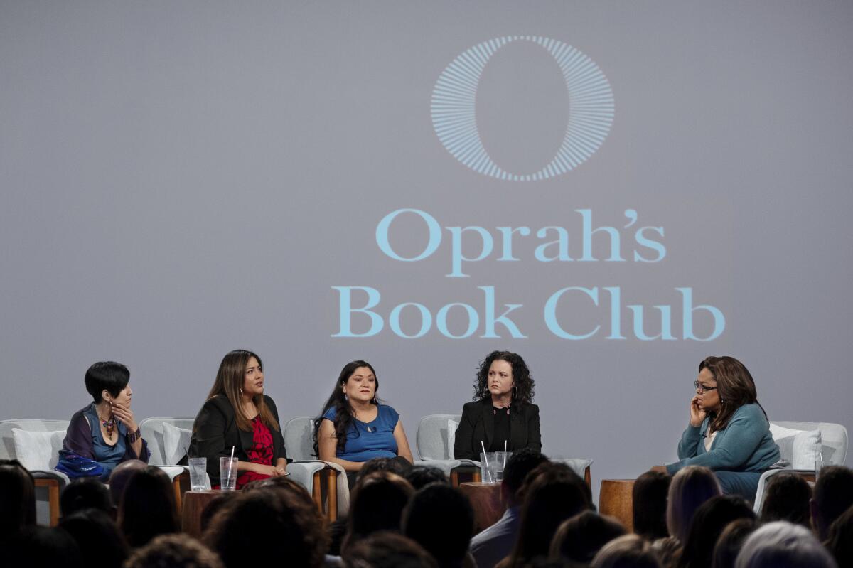 Oprah Winfrey, right, hosts a taping of Oprah's Book Club with Jeanine Cummins, author of "American Dirt," second from right, and panelists Esther J. Cepeda, left, Julissa Arce and Reyna Grande in Tuscon, Ariz., on Feb. 13, 2020.
