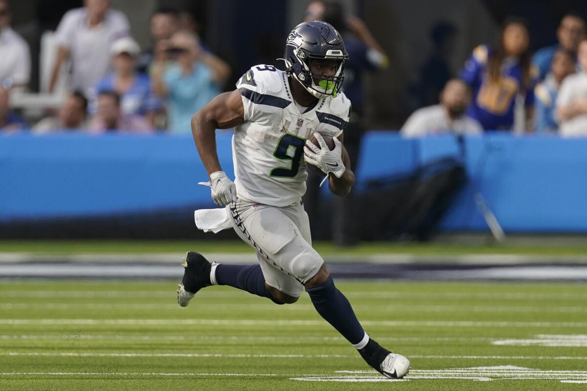 Seattle Seahawks running back Kenneth Walker III runs with the ball during the second half Sunday.