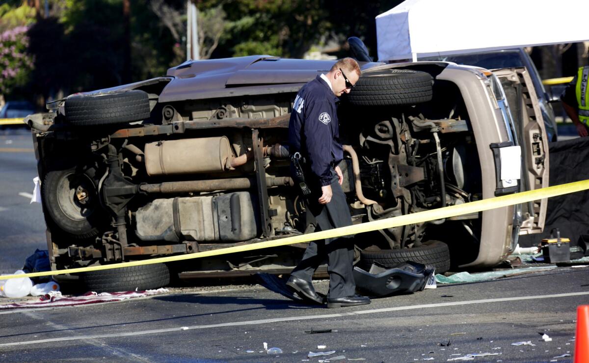 An LAPD investigator at the scene of a fatal crash in North Hills at Parthenia Street and Haskell Avenue on Thursday.