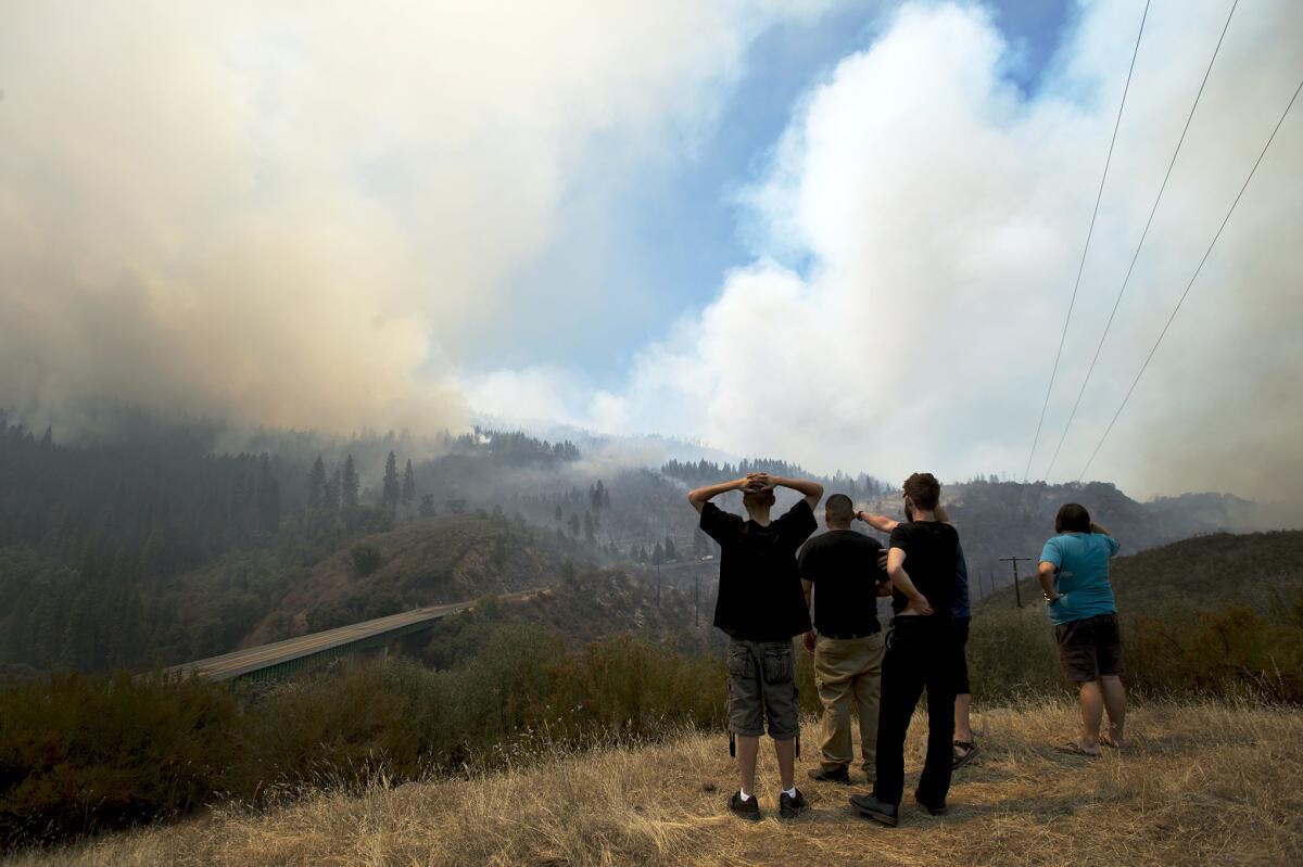 Friends Mike Geiser, Rene Auitia, Marcos Lopez, Ashton Humphrey and Nick Ward look out over the Tuolumne River canyon as the Rim fire moves east along Highway 120 in the Stanislaus National Forest.