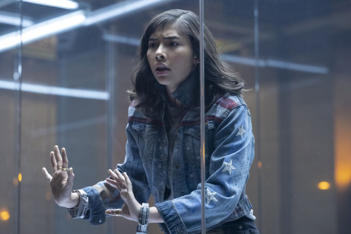 A teenage girl trapped in a clear cage