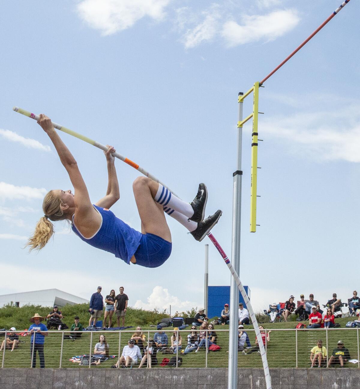 Westlake sophomore Paige Sommers practices the pole vault before the start of the event.