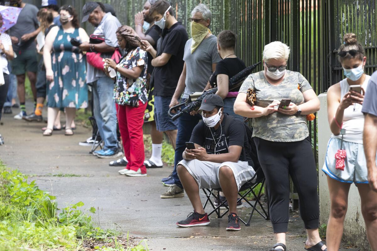 Voters wait in a long line to cast their ballots at an Atlanta polling site on Tuesday.