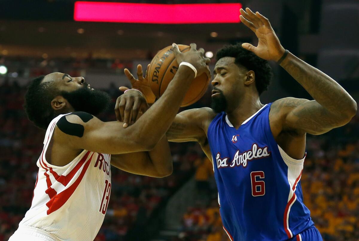Houston guard James Harden and Clippers big man DeAndre Jordan fight for a rebound during Game 5 of the second-round playoff series between the Clipper and Rockets.