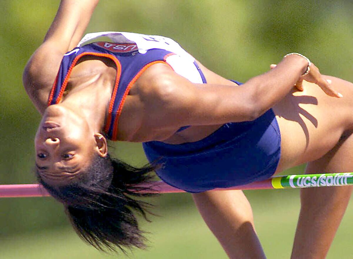 Nicole Haynes clears the bar on the way to finishing third in the heptathlon at the Pan Am Games in Winnipeg, Canada, in 1999.