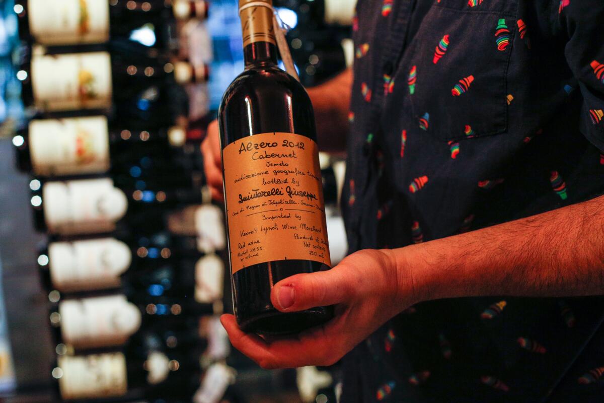 Nick Martinelle, manager of Lincoln Fine Wines, holds a bottle of Giuseppe Quintarelli