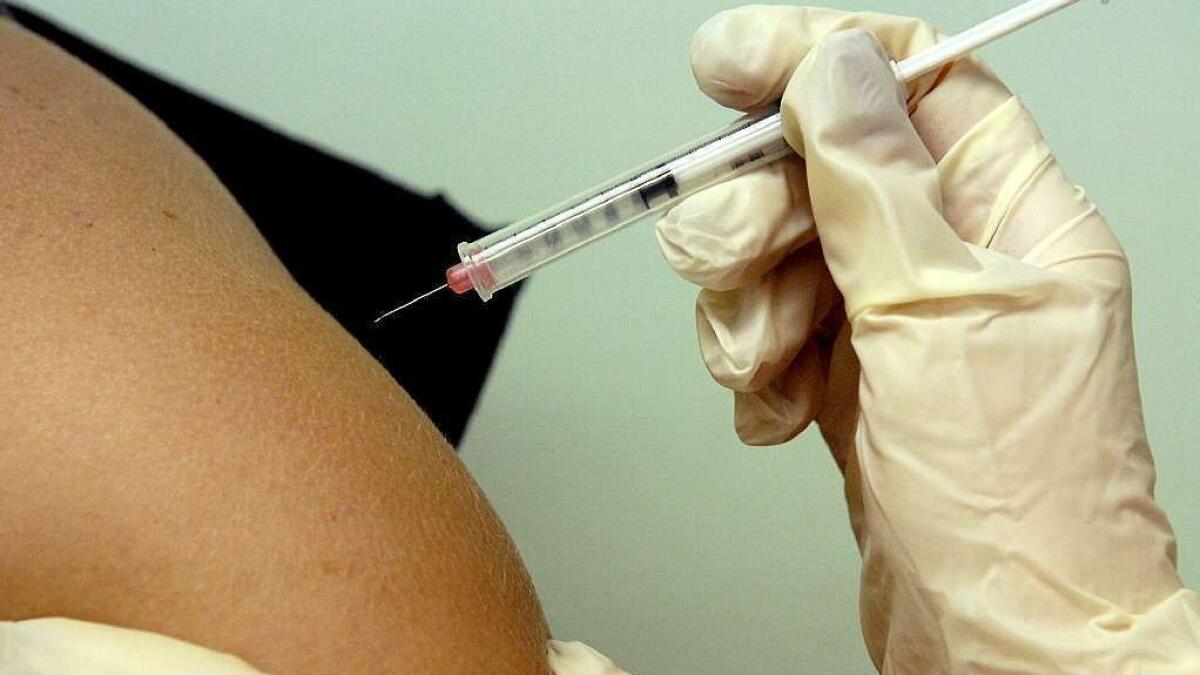 A nurse administers an HPV vaccine, which was recently recommended for adults up to age 26.