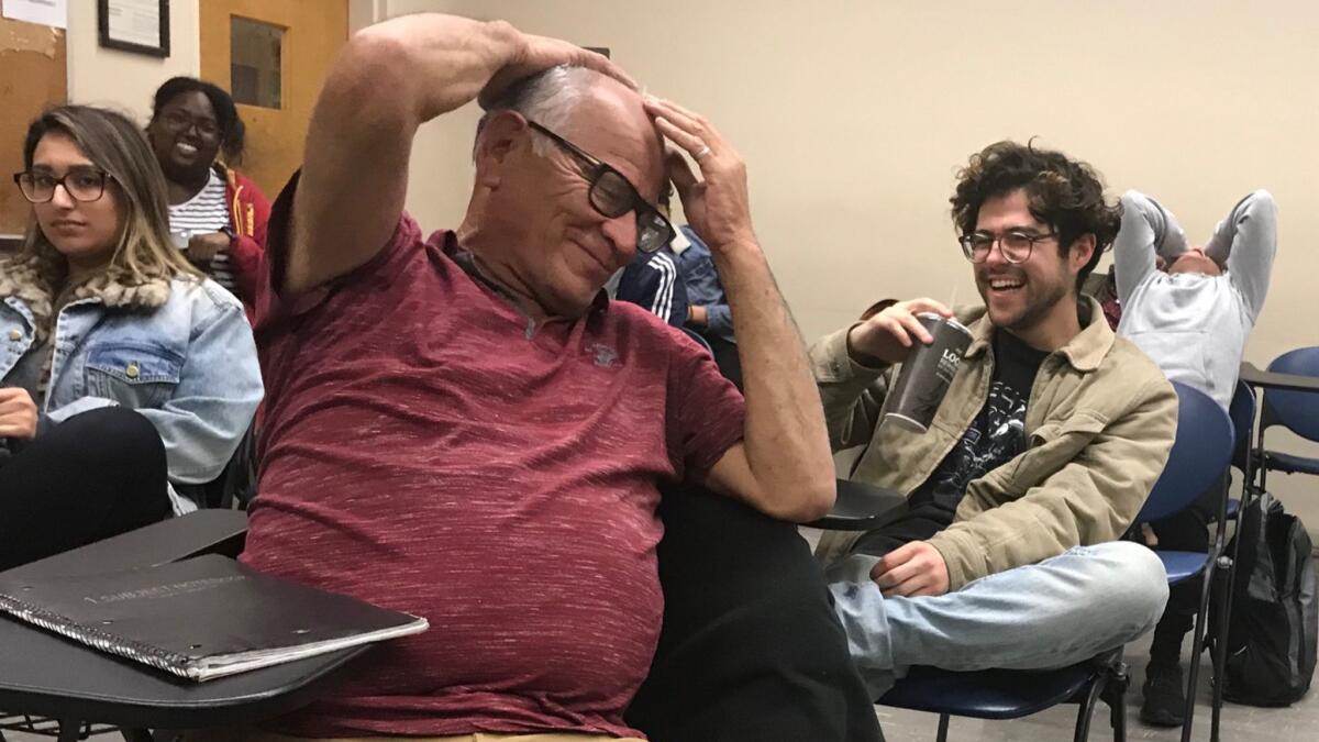 Jerry Valencia laughs during class at Cal State Los Angeles recently. Valencia is a 63-year-old junior at the school.