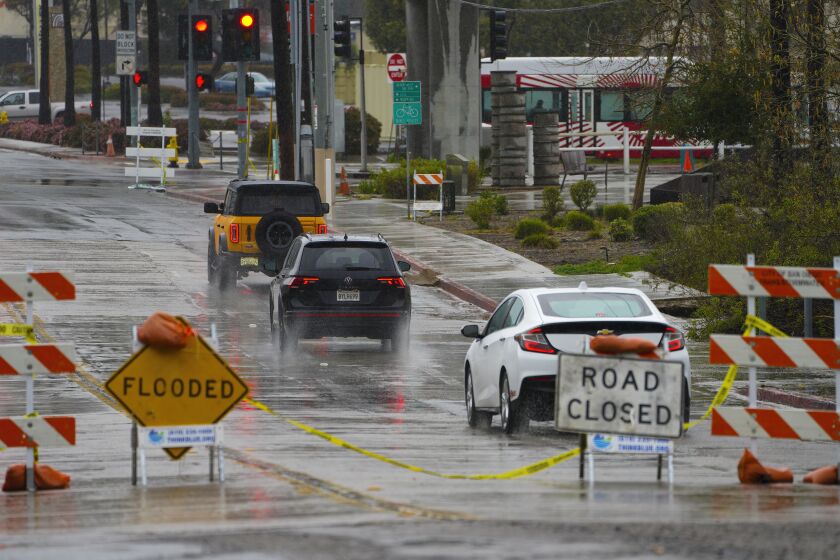 San Diego, CA - February 25: On Saturday, Feb. 25, 2023, Fashion Valley Road was closed, however drivers drove around posted “Flooded” and “Roads Closed” signs to get to the Fashion Valley and Friars Road. (Nelvin C. Cepeda / The San Diego Union-Tribune)