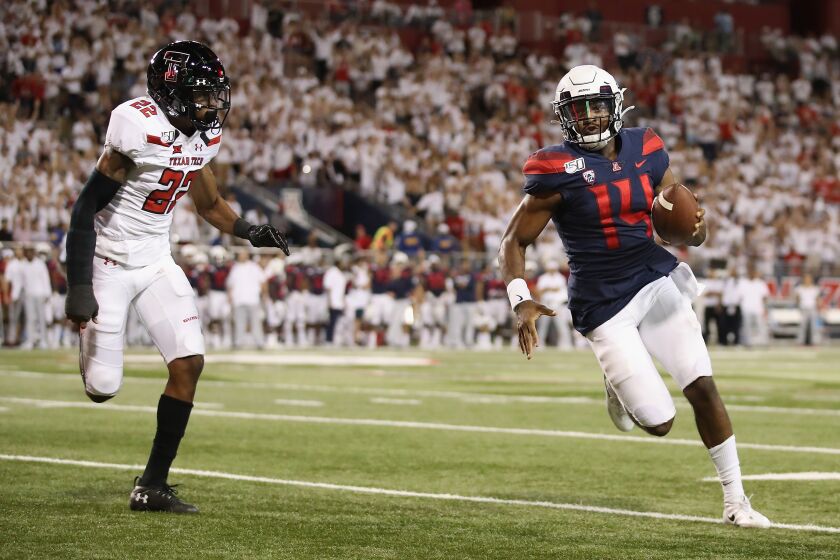TUCSON, ARIZONA - SEPTEMBER 14: Quarterback Khalil Tate #14 of the Arizona Wildcats rushes the football past cornerback Ja'Marcus Ingram #22 of the Texas Tech Red Raiders during the second half of the NCAAF game at Arizona Stadium on September 14, 2019 in Tucson, Arizona. (Photo by Christian Petersen/Getty Images) ** OUTS - ELSENT, FPG, CM - OUTS * NM, PH, VA if sourced by CT, LA or MoD **