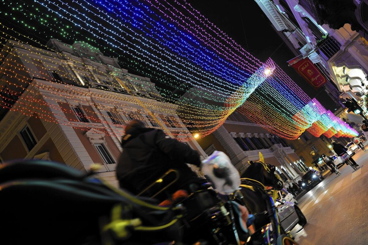 Rainbow lights line one of Rome's main shopping streets last month. "I can do whatever I want in the city center of Rome, but ... people in the suburbs [and in other cities] continue to live hidden," one man said.