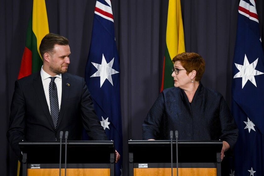 Australian Foreign Affairs Minister Marise Payne, right, and Lithuania's counterpart Gabrielius Landsbergis hold a press conference at Parliament House in Canberra, Australia, Wednesday, Feb. 9, 2022. The foreign ministers called on like-minded countries to join forces against Chinese economic coercion. (Lukas Coch/AAP Image via AP)