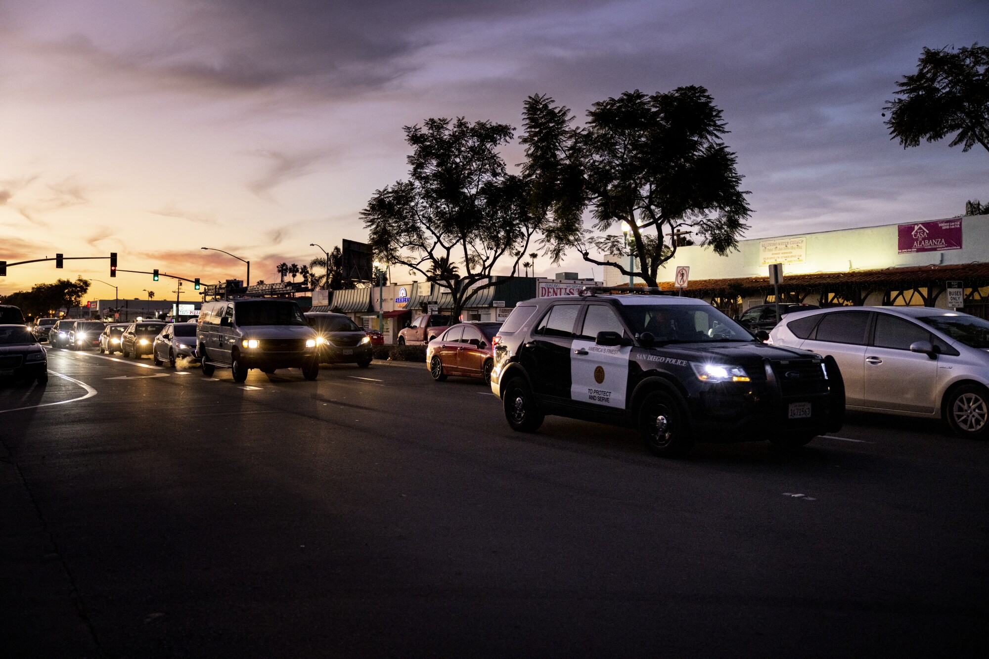 A San Diego police vehicle patrols along El Cajon Boulevard at sunset in the Teralta West neighborhood  Wednesday.