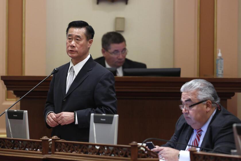 State Sen. Leland Yee (D-San Francisco), left, speaks on a bill at the Capitol in Sacramento in January 2014. Yee was indicted in March 2014 on charges of accepting $62,000 in campaign contributions in return for legislative favors and offering to arrange the sale of machine guns and shoulder-fired missiles to an undercover FBI agent posing as a mob figure.