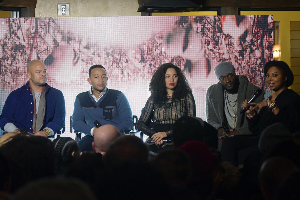 Director Anthony Hemingway, left, producer John Legend, actors Jurnee Smollett-Bell and Aldis Hodge, and writer Misha Green speak at WGN America's "Underground" panel at the Blackhouse Foundation in 2017.