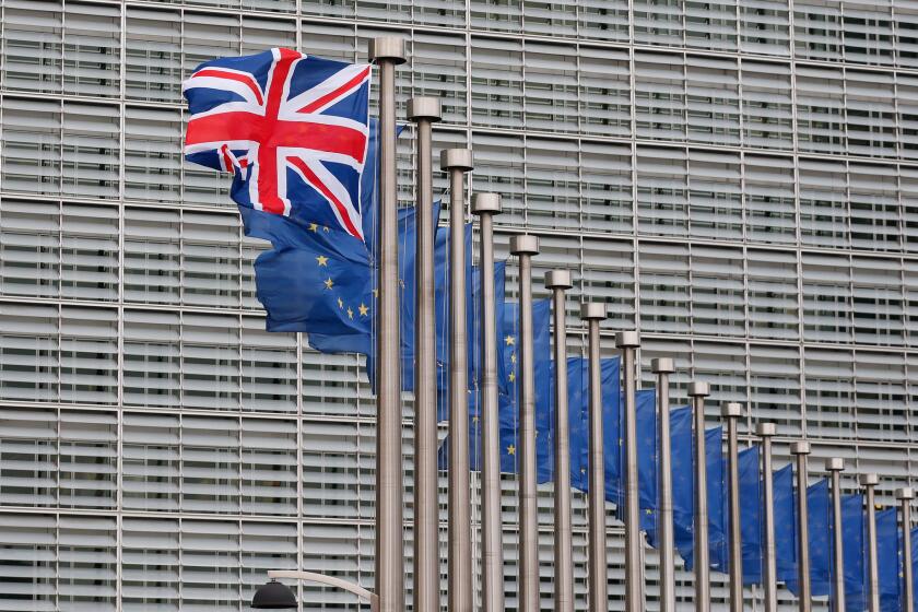 The British Union Jack flutters next to European Union flags at the European Commission in Brussels, Belgium.