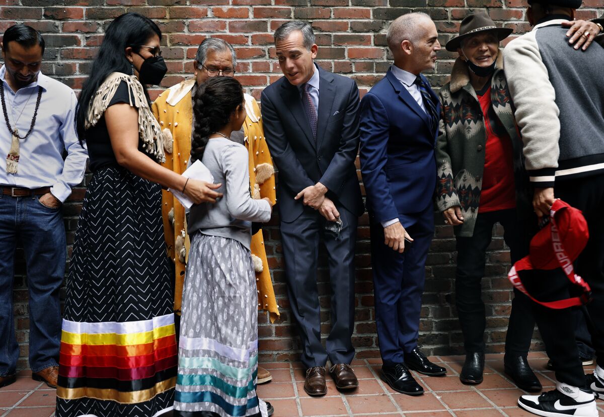 Mayor Eric Garcetti talks with members of the Gabrieleno/Tongva tribe, left, including 9-year-old Ellie Morales Recalde.