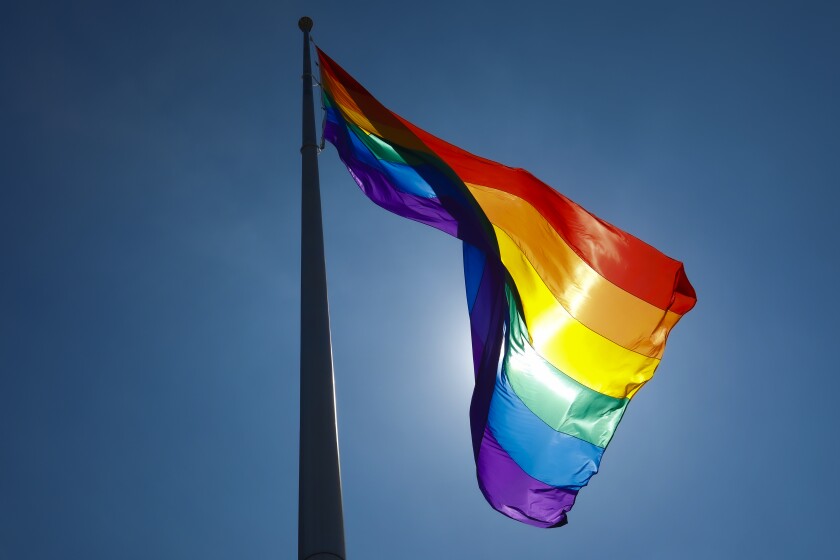 On the flag pole on the corner of University Avenue and Normal Street in Hillcrest, a large LGBT flag flag was flown