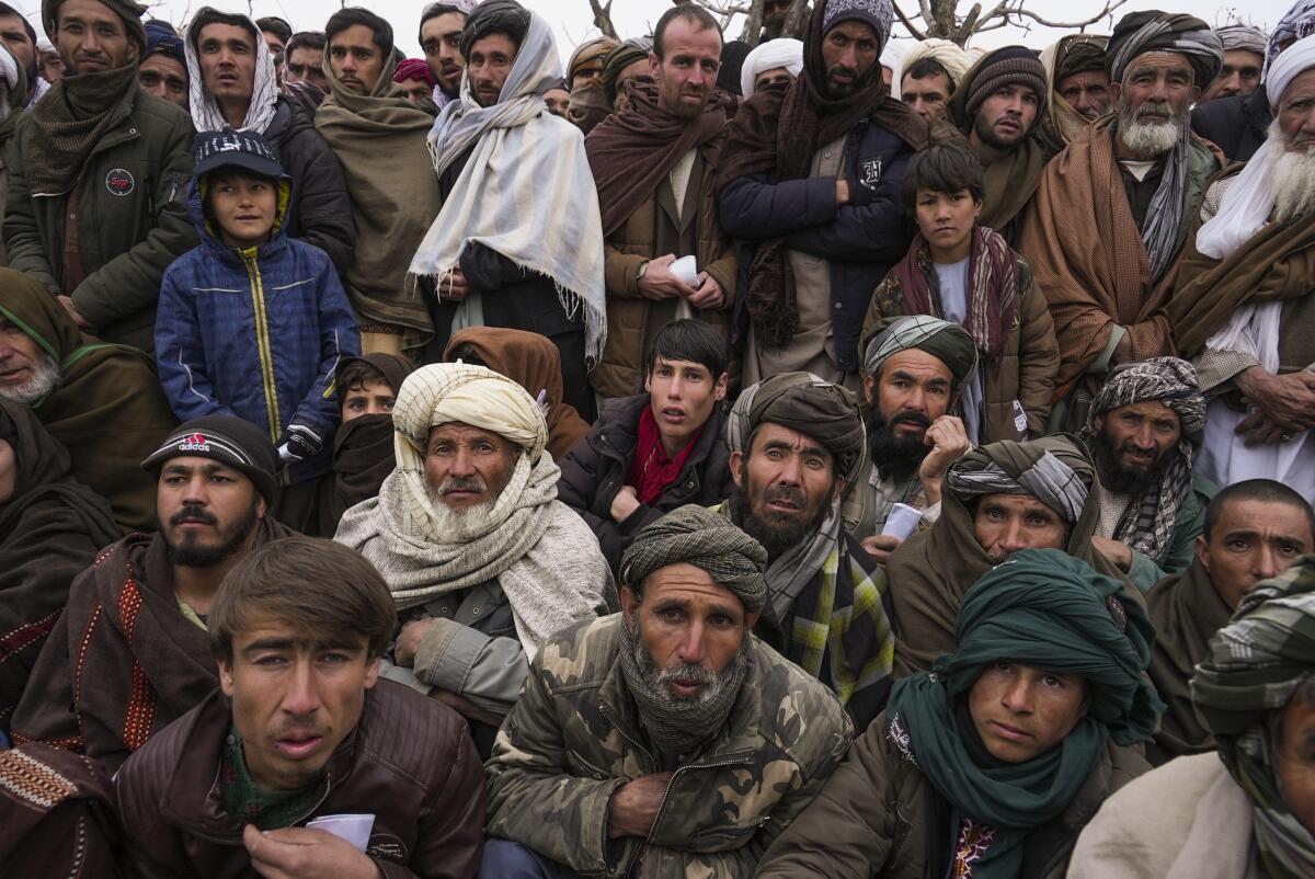 Afghan men gathering to apply for humanitarian aid