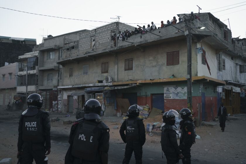 Police in riot gear stand guard during clashes with demonstrators in Dakar, Senegal, Saturday, June 3, 2023. The clashes first broke out, later this week, after opposition leader Ousmane Sonko was convicted of corrupting youth and sentenced to two years in prison. (AP Photo/Leo Correa)